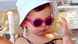 Criança-segurando-óculos-escuro-rosa