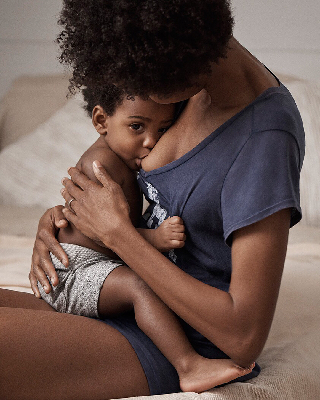 Mulher negra amamentando criança de um ano - amamentação prolongada