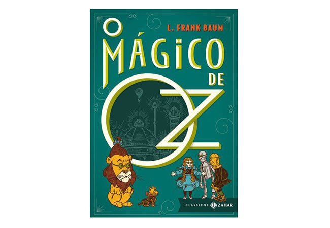 capa do livro O Mágico de Oz: ilustração de um leão maior, ao lado de uma garota, um homem de lata e um espantalho