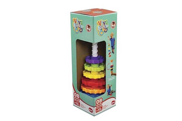 Giro-Mágico-Dismat Caixa de papelão com abertura que deixa aparente uma haste com várias peças coloridas empilhadas, que se parecem com engrenagens