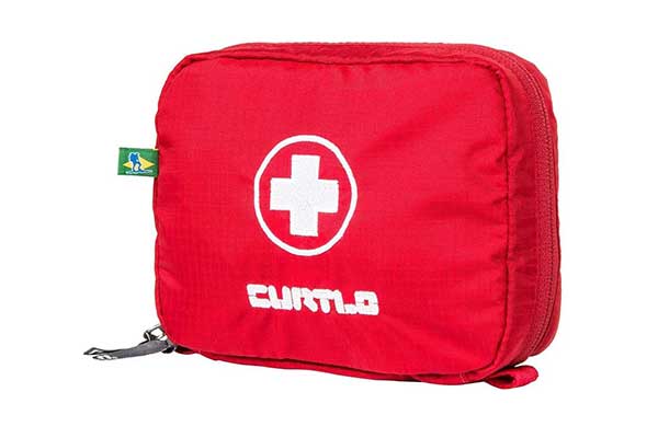 Bolsa-Kit-Primeiros-Socorros-P,-Curtlo nécessaire retangular de tecido. Ela é vermelha e tem uma estampa de cruz branca