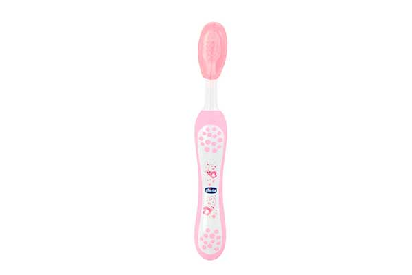 escova de dente infantil branca, com detalhes em rosa. Ela está posicionada na vertical